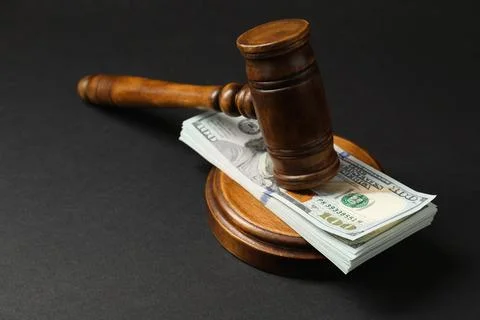 Law gavel with stack of dollars on black table, closeup Stock Photos