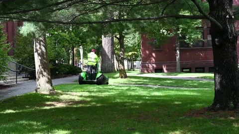 Lawn cutting with a zero-turn mower at Harvard University, 4K Stock Footage 219084173