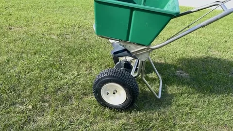 Lawn Fertilizer Spreader On Grass Stock Footage 335668215