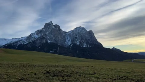 Lawn field in the evening in front of mountain Stock Footage 233258039