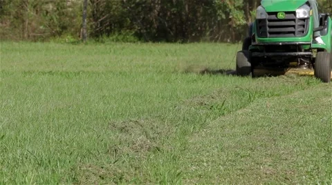 Lawn mower cutting football camp Stock Footage