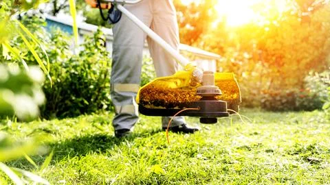 Lawn mower with grass trimmer Stock Photos