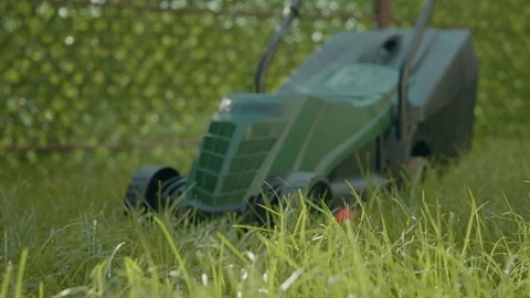 Lawn mower ready on terrace for grass cutting and maintenance activity Stock Footage 318831787