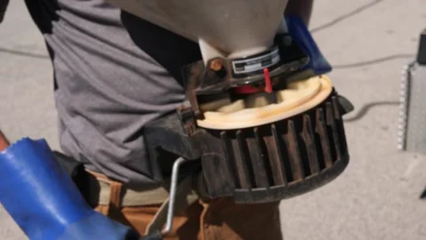 Lawn Technician Using A Chestpack Spreader Stock Footage 139149022