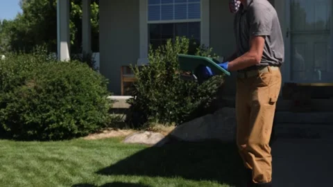 Lawn Technician Using Hand Spreader Stock-Footage 139149547