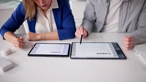 Lawyer Carefully Reviews Contract Documents, Explaining Details Stock Footage 331519787