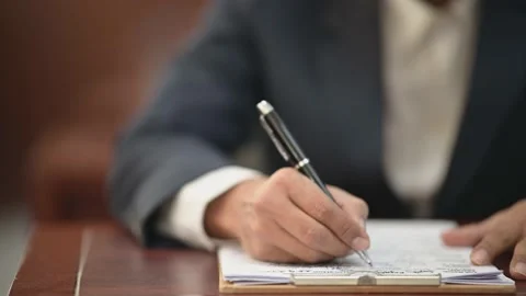 The lawyer is carrying a pen to write a case record in the courtroom Stock-Footage 137517077