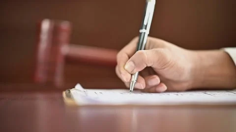 The lawyer is carrying a pen to write a case record in the courtroom Stock-Footage 137517121