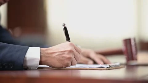 The lawyer is carrying a pen to write a case record in the courtroom Stock Footage 137517130