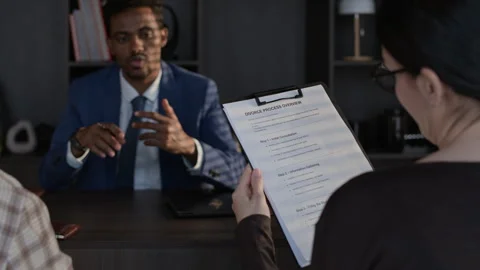 Lawyer Communicating with Clients, Showing Document Stock Footage 334729345