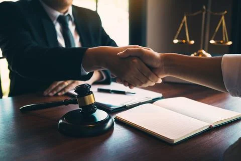 Lawyer is currently shaking hands with the client about the success in reso.. Stock Photos