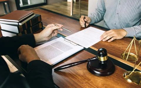 Lawyer is explaining about the wrongdoing laws regarding fraud to the clien.. Stock Photos