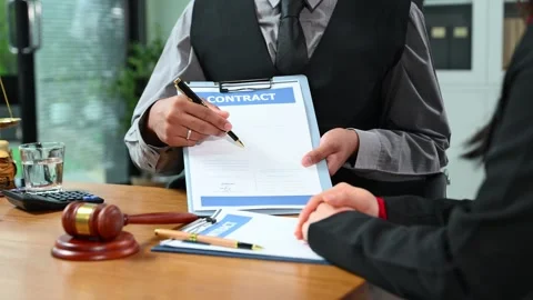 Lawyer explains contract details to client in office meeting. A professiona.. Video stock 312774447