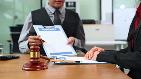 Lawyer explains contract details to client in office meeting. A professiona.. Stock Footage 312774468