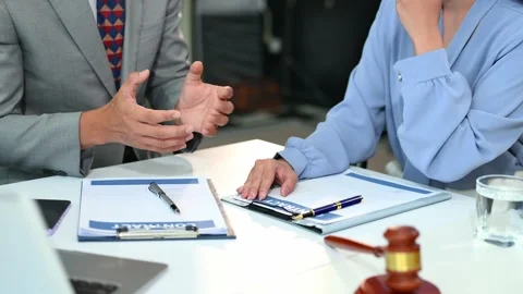 Lawyer offers support to stressed client during legal meeting. Justice, pap.. Stock Footage 312848868