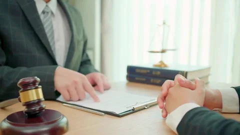 Lawyer Pointing at Document for Client During Meeting Stock Footage 320038761