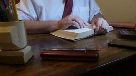 Lawyer reading civil code law book at his office desk Stock Footage 56722256