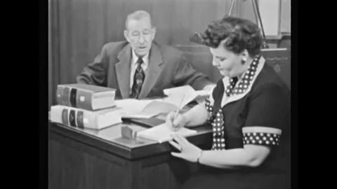 A lawyer researches as does a man trying to prove his citizenship, at the Vídeos de archivo 147391453