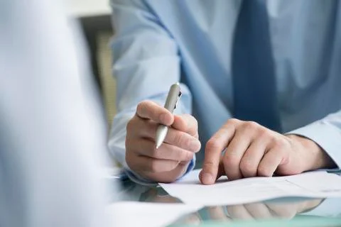 Lawyer reviewing document with client Stock Photos