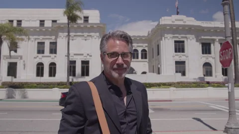 Lawyer Standing Looking Towards Camera with Courthouse Behind Him Stock Footage 270399023