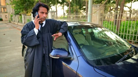 Lawyer talking on phone while leaning on car Stock Footage 278022265