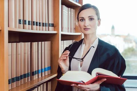 Lawyer working on a difficult case reading in the library Foto stock