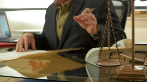 Lawyer working in his modern office focus on scales of justice 4k Stock Footage