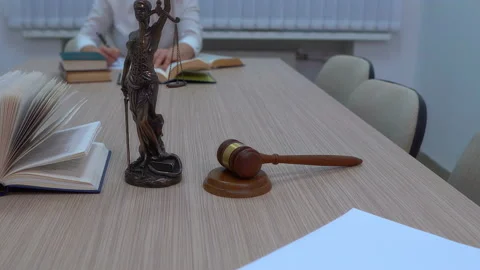 A lawyer in the workplace examines documents and legislation Stock Footage 100201757