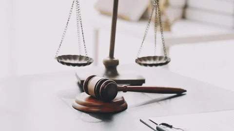 Lawyer write drafts a legal document at a desk with stationery and a laptop.. Stockbeeldmateriaal 304846983