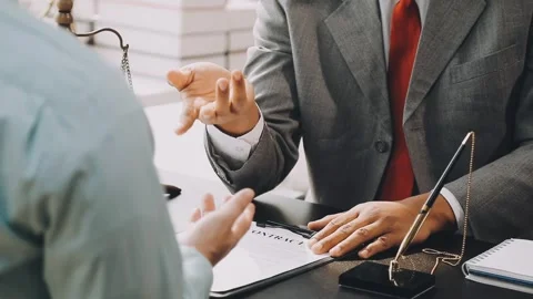 Lawyer write drafts a legal document at a desk with stationery and a laptop.. Stock Footage 304846986