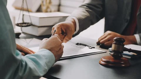 Lawyer write drafts a legal document at a desk with stationery and a laptop.. Stock Footage 304846987