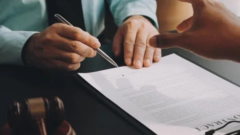 Lawyer write drafts a legal document at a desk with stationery and a laptop.. Stock Footage 304846988