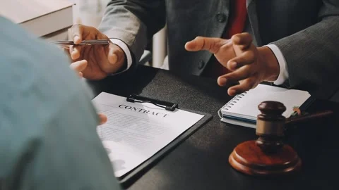 Lawyer write drafts a legal document at a desk with stationery and a laptop.. Stock Footage 304846989