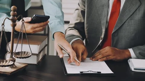Lawyer write drafts a legal document at a desk with stationery and a laptop.. Stock Footage 304846992