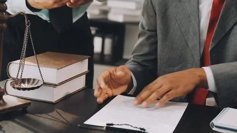 Lawyer write drafts a legal document at a desk with stationery and a laptop.. Stock Footage 304846993