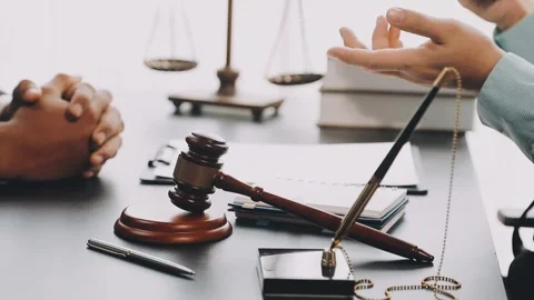Lawyer write drafts a legal document at a desk with stationery and a laptop.. Stock Footage 304846998