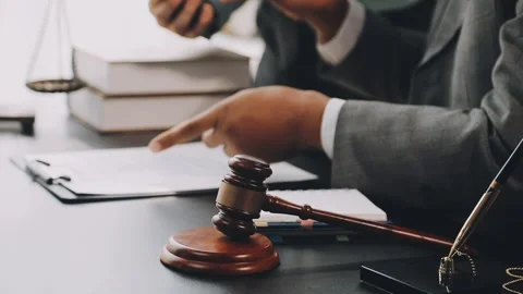 Lawyer write drafts a legal document at a desk with stationery and a laptop.. Stock Footage 304847000