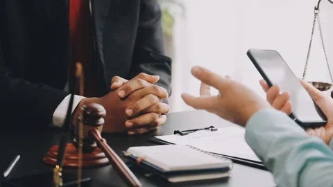Lawyer write drafts a legal document at a desk with stationery and a laptop.. Stock Footage 304847006