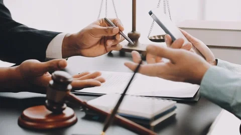 Lawyer write drafts a legal document at a desk with stationery and a laptop.. Stock Footage 304847009