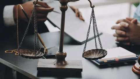 Lawyer write drafts a legal document at a desk with stationery and a laptop.. Stock Footage 304847018