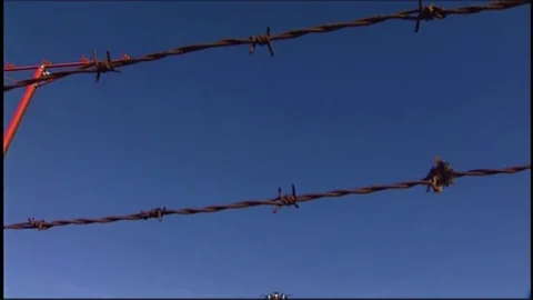 LAX plane lands over barbed wire V1-0027 Stock Footage 76197667