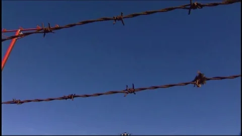LAX plane lands over barbed wire Stock Footage 76197668