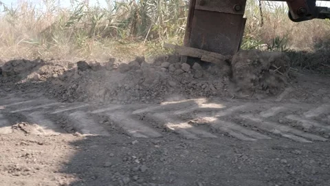 Lay the cable in the ground with a large wheeled tractor. Close up 스톡 동영상 247991102