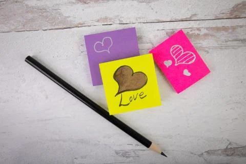 Lay flat background with posted notes hearts and the word love Stock Photos
