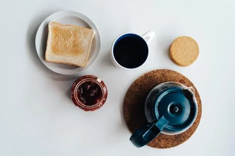 Lay flat of breakfast with coffee, biscuits and toast with jam Stock Photos