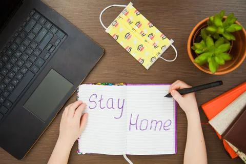 Lay flat image child hands medical antiviral mask write stay home 库存照片