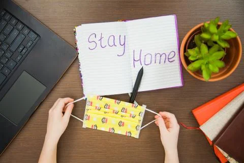 Lay flat image child hands medical antiviral mask write stay home Stock Photos