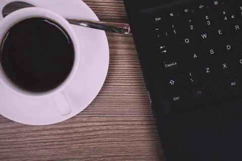 Lay flat image of a laptop and coffee cup Vintage Retro Filter. Stock Photos