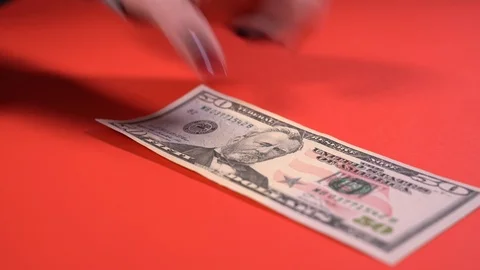 Lay out dollar bills on a red table Vídeo Stock 127474735
