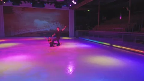 Layback spin figure skating element with two skaters on ice rink Stock Footage 137456010